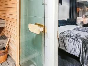 a bedroom with a bed and a glass shower door at Holiday Home Levin tuisku by Interhome in Levi