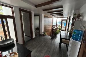 a living room with a table and a dining room at Bagaan Villa Homestay in Ilām