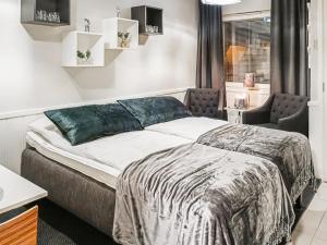a bedroom with a bed and a chair in it at Holiday Home Levin tuisku by Interhome in Levi