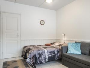 a bedroom with a bed and a couch at Holiday Home Levi star 1503 by Interhome in Levi +5 photos