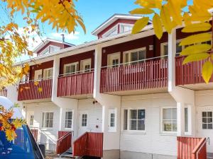 a building with red and white balconies on it at Holiday Home Levi star 1503 by Interhome in Levi