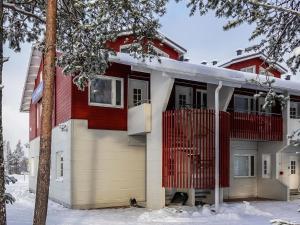 a red and white house in the snow at Holiday Home Moonlight 201 by Interhome in Levi