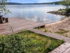 a wooden dock on the shore of a lake at Holiday Home Aamunkoi by Interhome in Veskoniemi