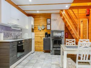 a kitchen with wooden walls and a wooden ceiling at Holiday Home Aslakit a by Interhome in Levi