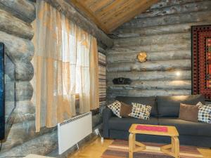 a living room with a couch and a table at Holiday Home Atokka by Interhome in Levi