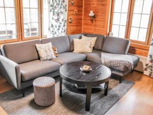 a living room with a couch and a table at Holiday Home Saikulevi by Interhome in Levi