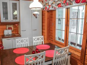 a kitchen with a table and chairs and windows at Holiday Home Saikulevi by Interhome in Levi +14 photos