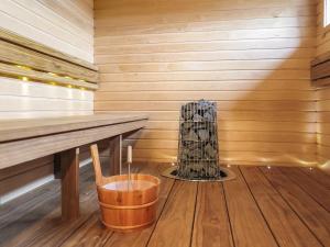 a sauna with a wooden bench and a vase at Holiday Home Karhu b by Interhome in Saariselka