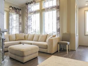 a living room with a couch and a chair at Holiday Home Karhu b by Interhome in Saariselka +17 photos