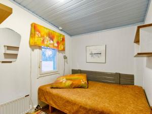 a bedroom with a bed with a pillow on it at Holiday Home Jousimaja by Interhome in Ylläsjärvi +6 photos