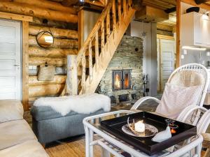 a living room with a couch and a fireplace at Holiday Home Peurankuoppa by Interhome in Lemmenjoki