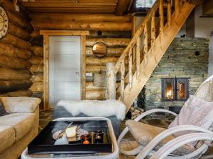 a log cabin living room with a coffee table at Holiday Home Peurankuoppa by Interhome in Lemmenjoki +25 photos