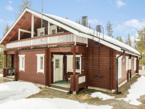 a wooden house with snow on the roof at Holiday Home Hirvas levi 2 by Interhome in Levi