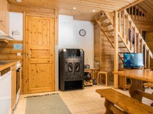a kitchen with a woodburning stove in a cabin at Holiday Home Hirvas levi 2 by Interhome in Levi