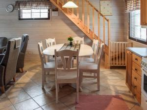 a dining room with a table and chairs at Holiday Home Ahonlaita by Interhome in Karvonen