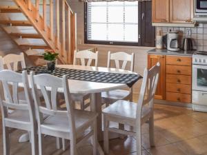 a kitchen with a dining room table and chairs at Holiday Home Ahonlaita by Interhome in Karvonen