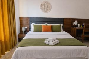 a bedroom with a bed with towels on it at Ima Ganga Hotel - Aesthetic, Quite Mountain View Rooms In Upper Tapovan with netflix, free airport pickup for 7 or more nights booking in Rishīkesh