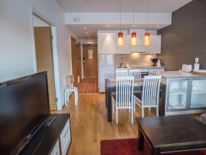 a kitchen and living room with a table and chairs at Holiday Home Ski chalet 6206 by Interhome in Ylläs