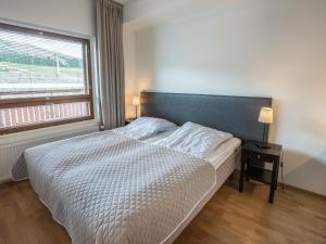 a bedroom with a bed with a large window at Holiday Home Ski chalet 6206 by Interhome in Ylläs +10 photos