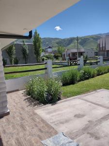a view of a yard with a fence and grass at Casita Tafí del Valle in Tafí del Valle