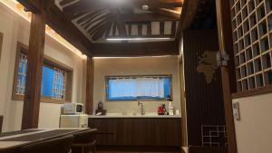 a kitchen with a sink and a window at Hanok Hyeyum in Jeonju +105 photos