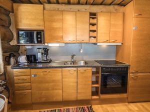a kitchen with wooden cabinets and a sink at Holiday Home Örtsylä a by Interhome in Salla