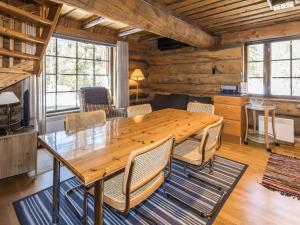 a dining room with a wooden table and chairs at Holiday Home Örtsylä a by Interhome in Salla