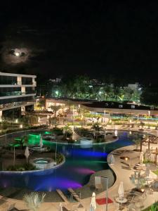 a view of a pool at night at Beach Class Verano Muro Alto in Porto De Galinhas
