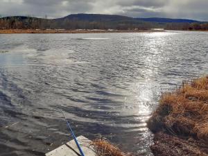 a body of water with a fishing pole in it at Holiday Home Hoviranta by Interhome in Veskoniemi