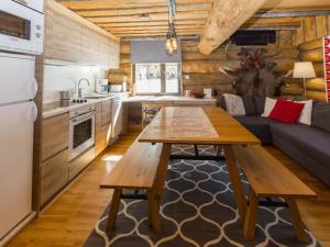 a kitchen and living room with a table and a couch at Holiday Home Örtsylä b by Interhome in Salla