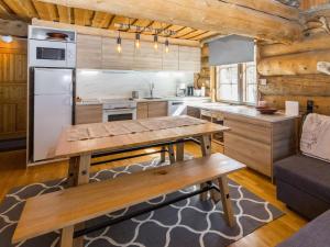 a kitchen with a table and a couch in a room at Holiday Home Örtsylä b by Interhome in Salla