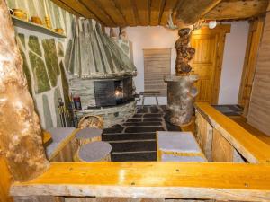 a living room with a stone fireplace in a cabin at Holiday Home Örtsylä b by Interhome in Salla