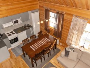 a kitchen and dining room with a table and chairs at Holiday Home Mervinrinne by Interhome in Luosto +14 photos