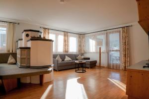 a living room with a couch and a table at AKTIV Apartments by Peak Stay in Leutasch