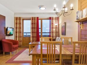 a dining room and living room with a table and chairs at Holiday Home Ylläs chalets a502 by Interhome in Ylläs
