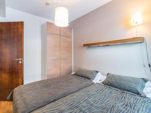 a bedroom with a bed with two pillows at Holiday Home Ylläs chalets 3210 by Interhome in Ylläs