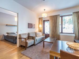 a living room with a couch and a table at Holiday Home Ylläs chalets 3210 by Interhome in Ylläs