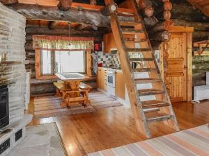 a kitchen with a ladder in a log cabin at Holiday Home Kulpakko 2 by Interhome in Tiainen