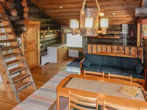 a living room with a couch and a table at Holiday Home Kulpakko 2 by Interhome in Tiainen
