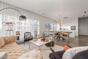a living room with a couch and a table at Unbeatable Central Location - Reykjavíks Most Exclusive Luxury Apartments in Reykjavík