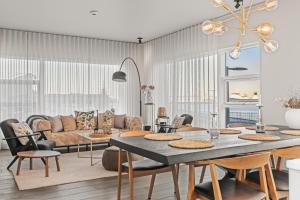 a living room with a table and a couch at Unbeatable Central Location - Reykjavíks Most Exclusive Luxury Apartments in Reykjavík +248 photos