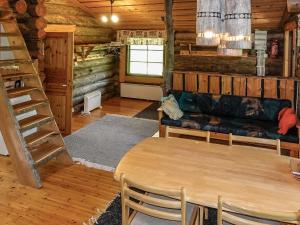 a living room with a couch and a table at Holiday Home Kulpakko 3 by Interhome in Tiainen