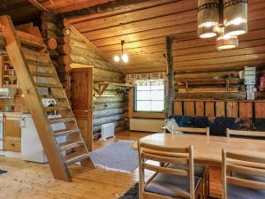 a kitchen and dining room with a table in a cabin at Holiday Home Kulpakko 3 by Interhome in Tiainen