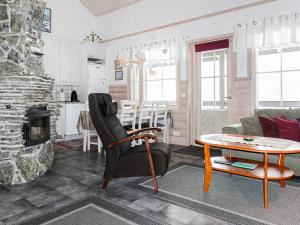 a living room with a couch and a table at Holiday Home Lustola b by Interhome in Luosto