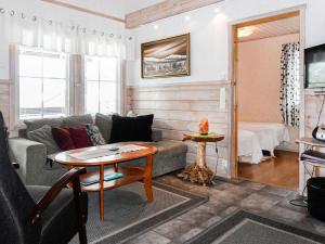 a living room with a couch and a table at Holiday Home Lustola b by Interhome in Luosto +22 photos