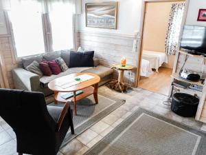 a living room with a couch and a table at Holiday Home Lustola b by Interhome in Luosto