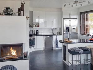 a kitchen with a fireplace in the middle of it at Holiday Home Villa ylläs 203 by Interhome in Ylläs