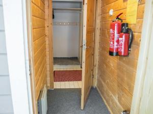 a small shower in a tiny house with a fire extinguisher at Holiday Home Tunturinvieri l3 by Interhome in Ylläsjärvi