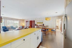 a kitchen and living room with a yellow counter top at Fawn Ledge in Jamaica