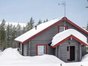 a small house with snow on the roof at Holiday Home Kerkänperä by Interhome in Luosto